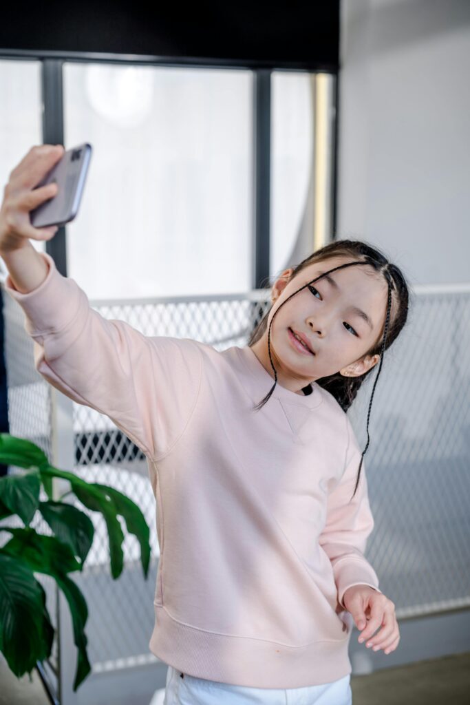 Young asian girl taking selfie