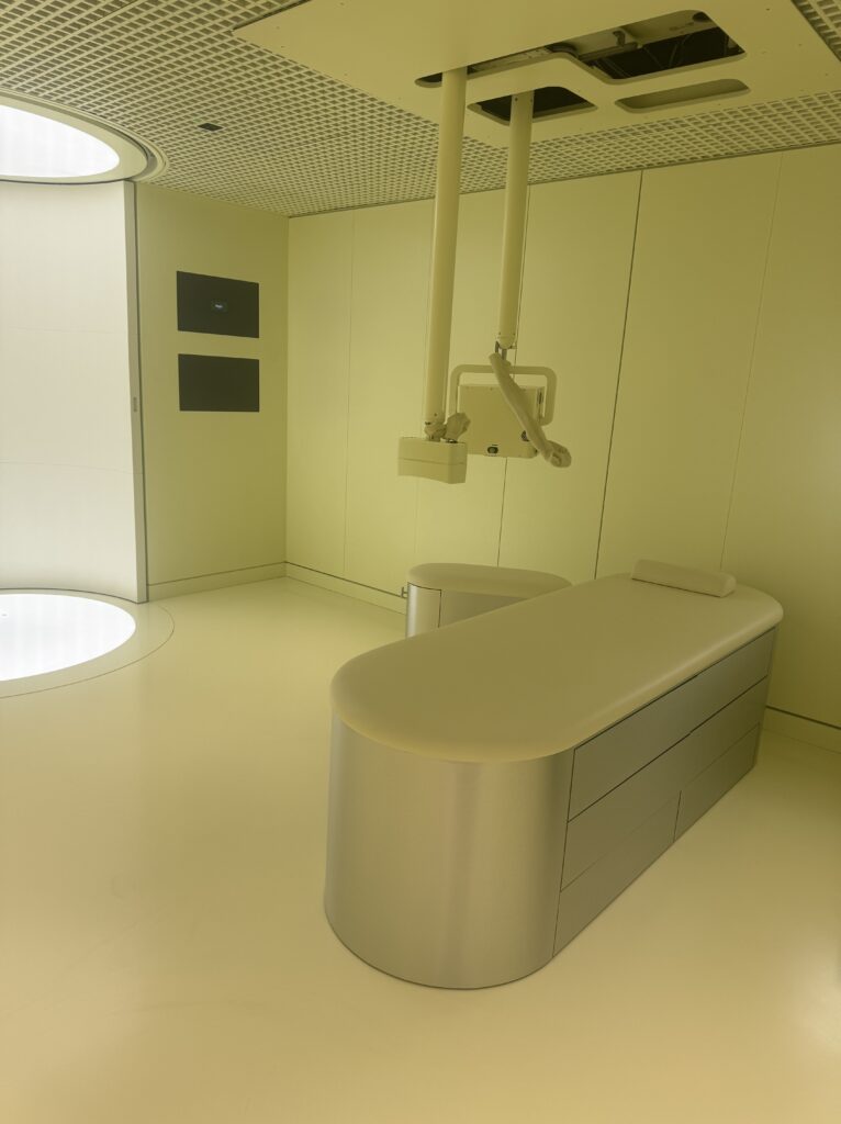 An elegant, soft yellow pastel examination room with soft lighting and modern design showcases Neko Health’s focus on creating a calming environment.