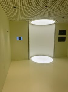A sleek, minimalistic examination room features curved furniture and glowing lights, reflecting Neko Health’s modern healthcare aesthetics.