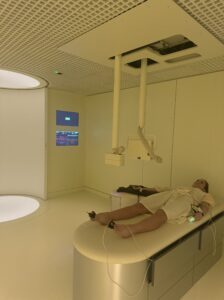 A patient lies on a futuristic examination table surrounded by advanced scanning technology, embodying Neko Health’s cutting-edge approach to diagnostics.