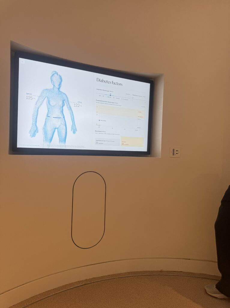 A sleek health screen shows a 3D body scan and detailed metrics, including diabetes risk factors, part of Neko Health’s personalized preventive healthcare insights.