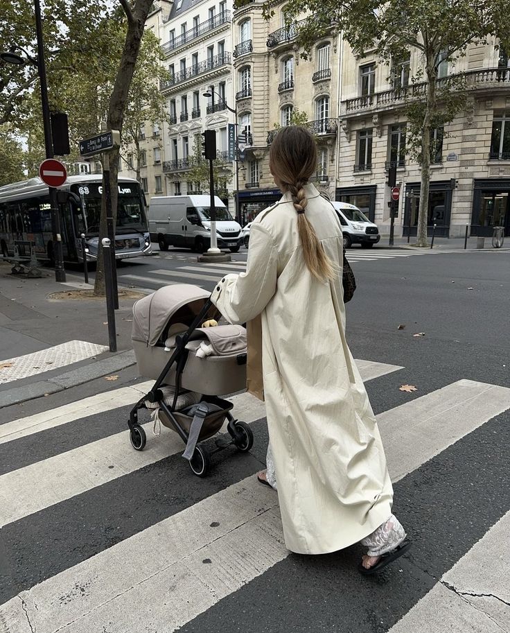 Mum pushing a pram in the city - Instagram captions for motherhood