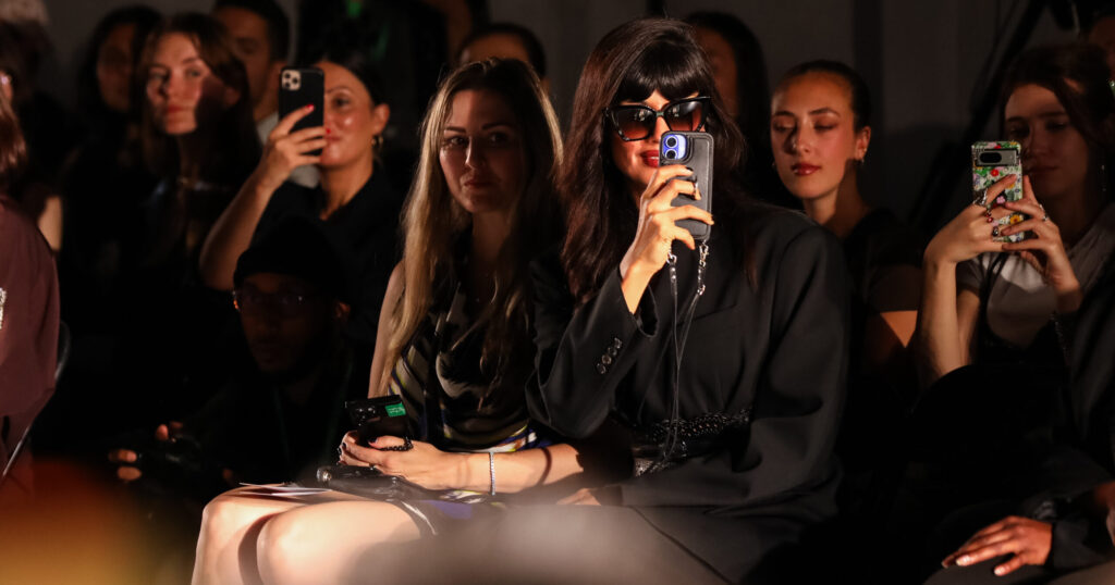 Jameela Jamil takes photos from the front row at Oxfam’s Style for Change runway during London Fashion Week.