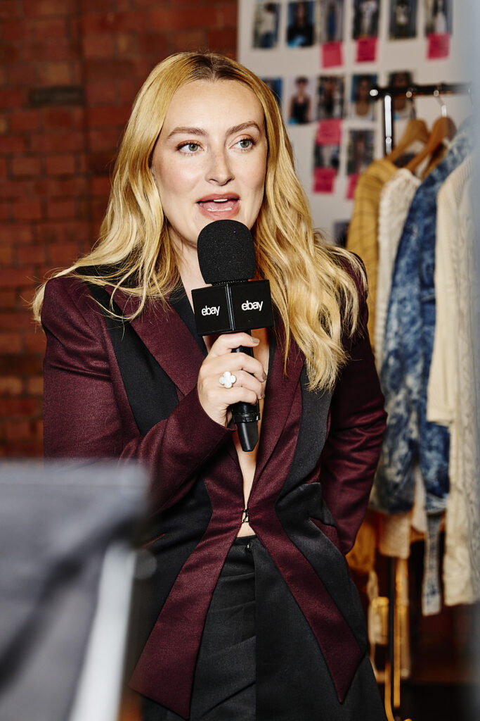 Amelia Dimoldenberg speaking backstage while hosting eBay’s Endless Runway fashion event at London Fashion Week.
