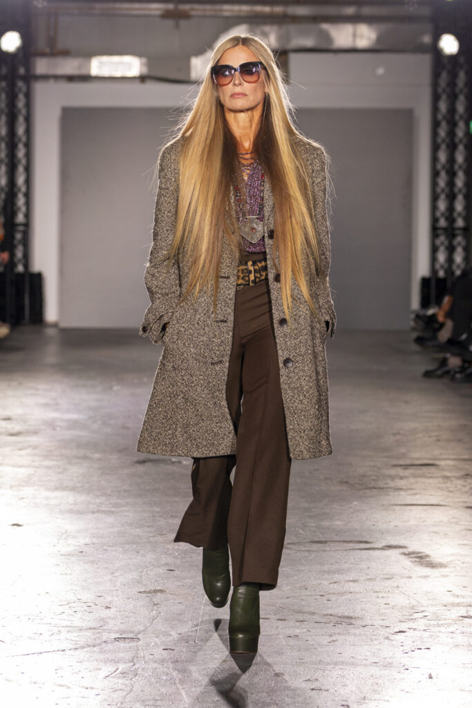 Laura Bailey models a second-hand tweed coat and wide-leg trousers with platform boots and oversized sunglasses at Oxfam’s Style for Change runway show.