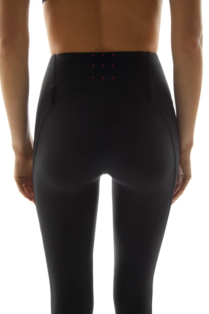 Back view of Coperni C+ leggings showing red illuminated dots symbolising the active probiotic technology within the bio-based textile.
