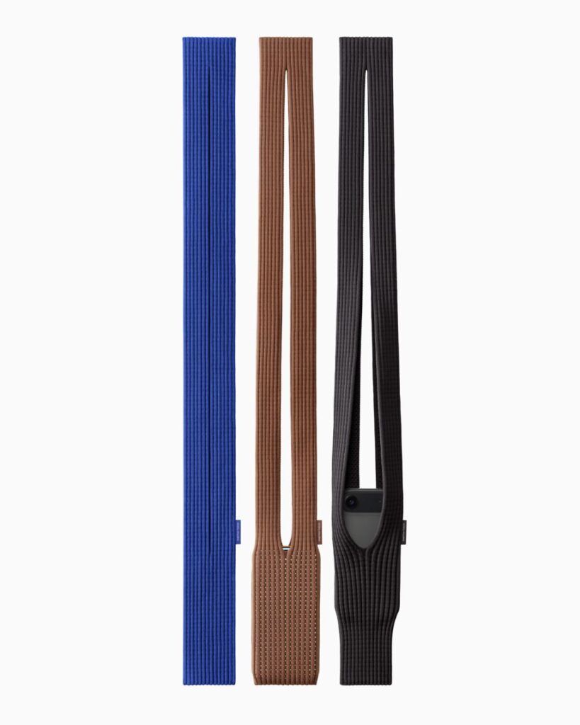 Three long-strap Issey Miyake iPhone Pocket accessories in blue, brown, and black, shown against a plain white background.