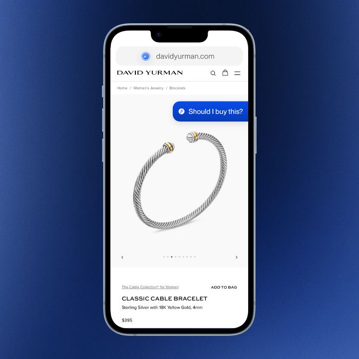 Close-up of a phone screen showing the Phia app on a David Yurman product page with AI shopping assistant prompt.