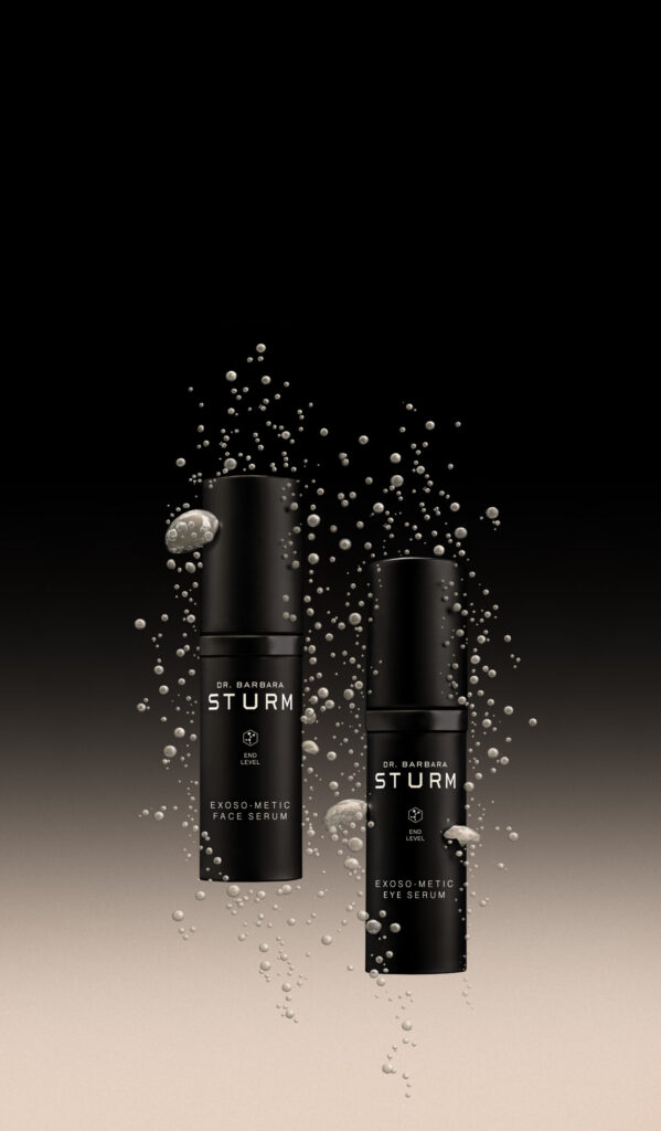 Two black bottles of Dr Barbara Sturm’s Exoso-Metic Face Serum and Eye Serum floating against a dark gradient background surrounded by rising micro-bubbles, creating a futuristic, science-driven aesthetic.