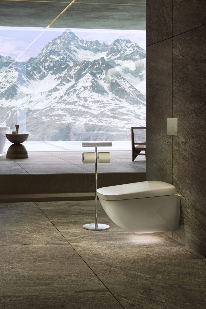 A luxury Japanese bathroom featuring a smart toilet set against a panoramic mountain view, illustrating how health-tracking toilet technology integrates into high-end, spa-inspired interiors.