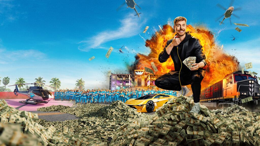 Promotional image for Beast Games season 2 on Prime Video UK featuring MrBeast surrounded by explosions, helicopters and piles of cash, representing high-stakes reality competition and creator-led streaming entertainment.