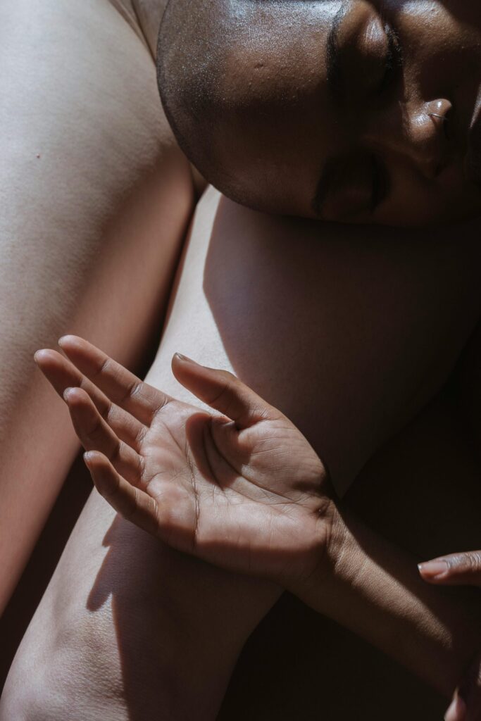 Close-up of hands and skin highlighting physical touch and sensory intimacy in contemporary relationships.