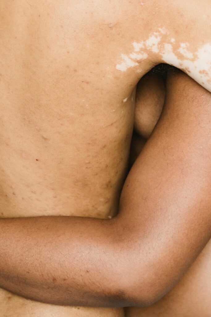 Abstract close-up of intertwined bodies symbolising physical intimacy and closeness in modern romantic relationships.
