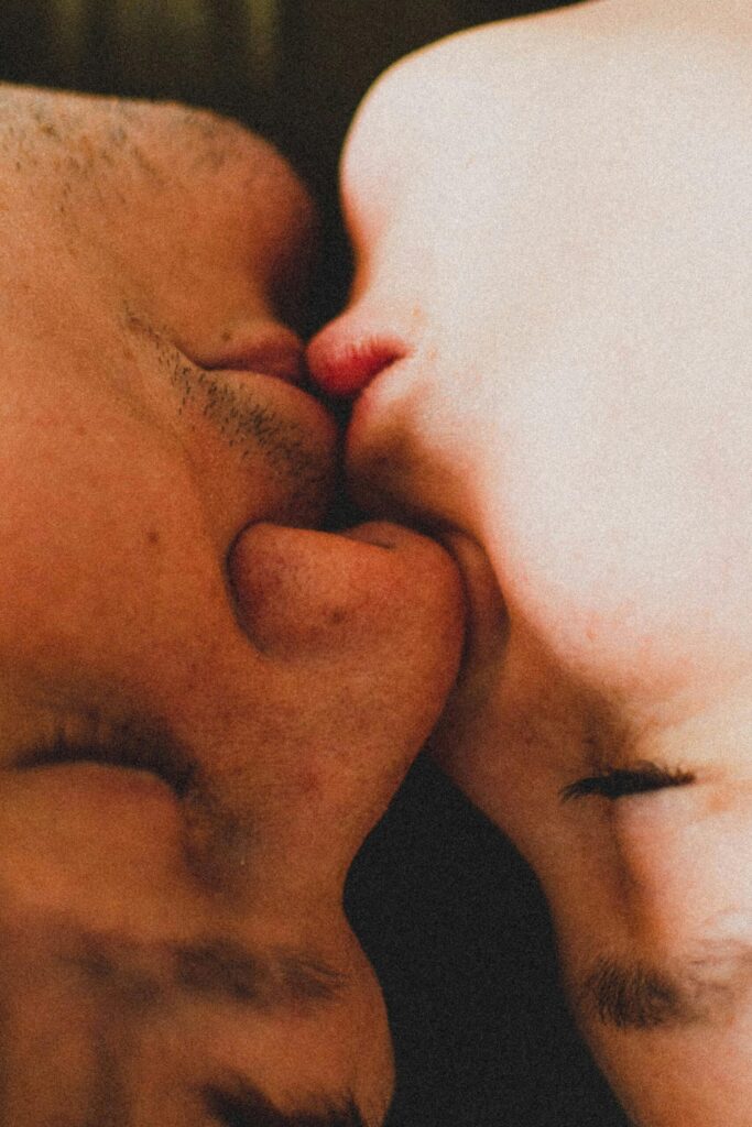 Close-up of two people kissing, representing real-life romantic connection and intimacy beyond digital dating platforms.