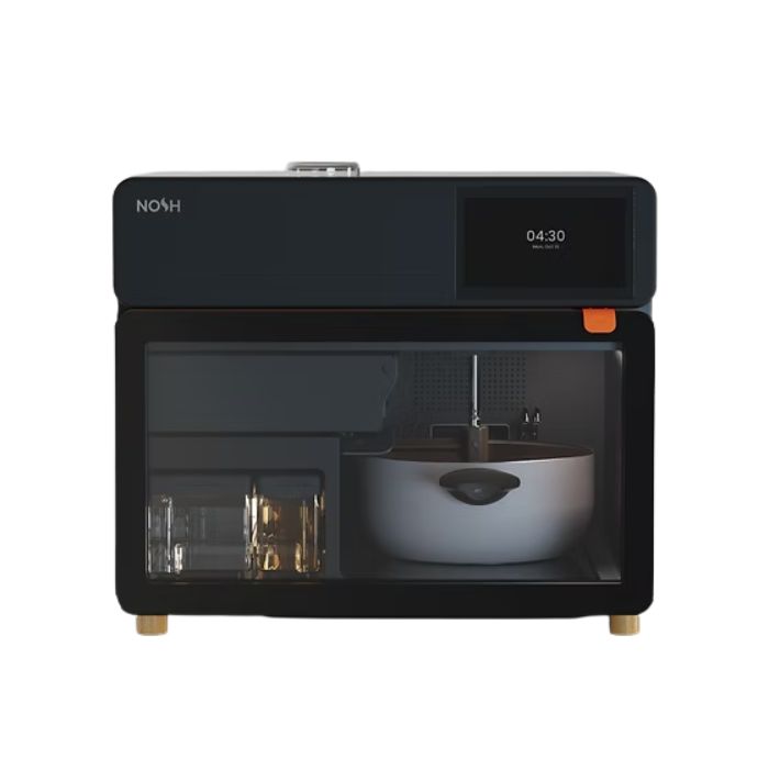 NOSH AI-powered smart cooker with internal compartments and digital display, designed to automate home cooking using artificial intelligence.