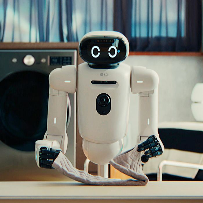 LG CLOiD home robot standing in a modern kitchen environment, demonstrating AI-powered household assistance including laundry folding and domestic task automation.