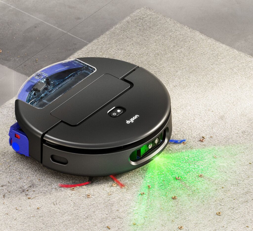 Dyson Spot+Scrub™ AI robot vacuum transitioning from hard floor to carpet, lifting its wet roller and activating boosted suction power for carpet-safe cleaning.