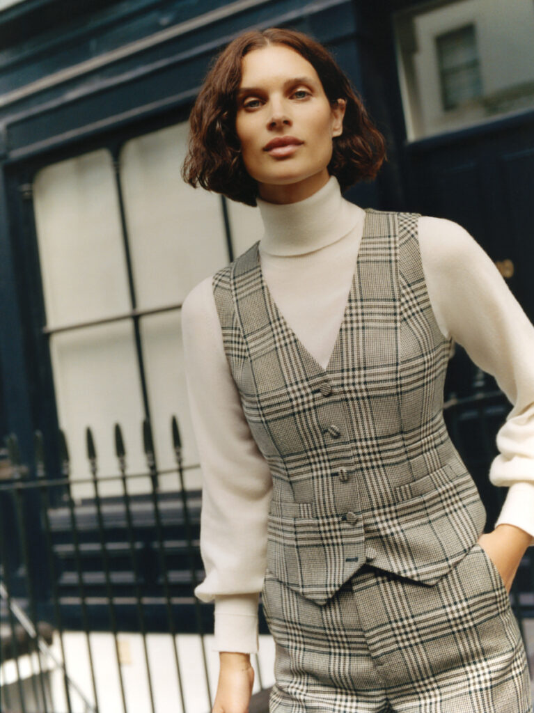 Model wearing Knatchbull tailored waistcoat and trousers layered over cream top, styled as modern womenswear tailoring.