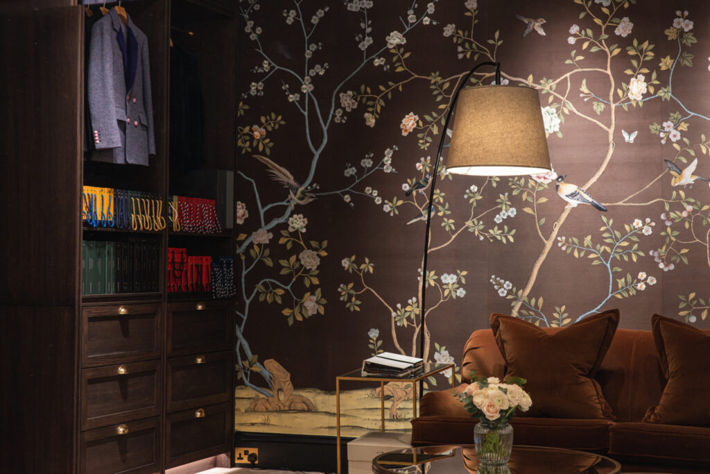 Knatchbull Savile Row interior featuring bespoke womenswear tailoring lounge with floral wallpaper, velvet seating, curated bookshelves and soft lighting inside 32 Savile Row.